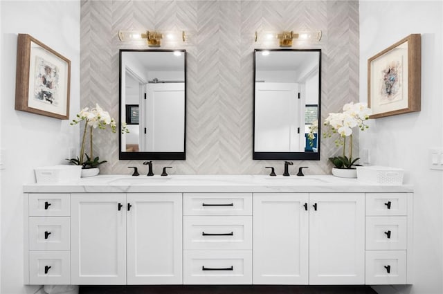 full bathroom with double vanity, decorative backsplash, and a sink