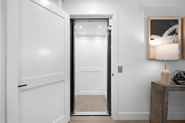 hallway with wood-type flooring