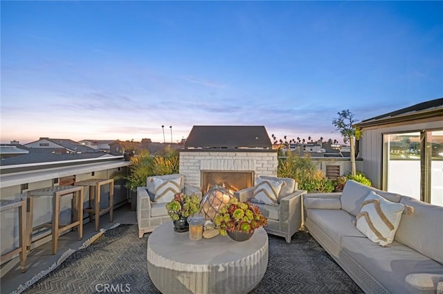 view of patio / terrace featuring an outdoor living space with a fireplace