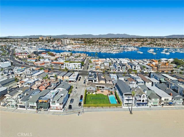 drone / aerial view featuring a water and mountain view