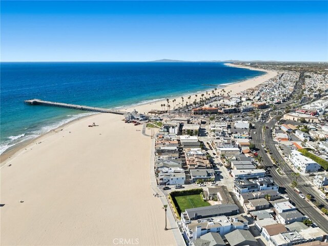 birds eye view of property with a water view and a view of the beach