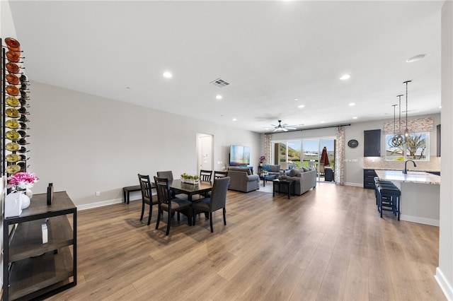 7631 Capstone Ct, Riverside, CA 92506 - dining area with light wood-style flooring, ceiling fan, recessed lighting, and baseboards