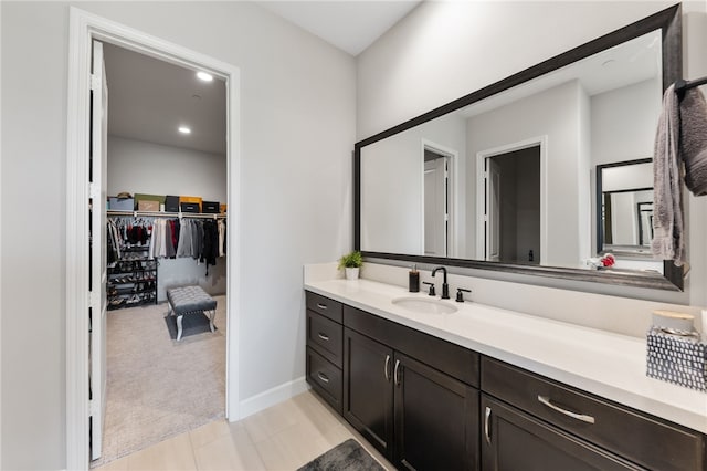 7631 Capstone Ct, Riverside, CA 92506 - bathroom with vanity, a walk in closet, and baseboards