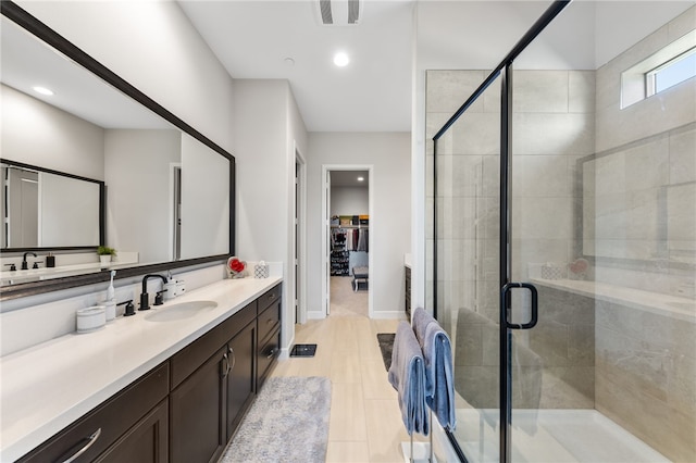 7631 Capstone Ct, Riverside, CA 92506 - bathroom with vanity, a stall shower, a walk in closet, recessed lighting, and baseboards