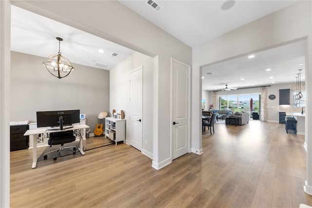7631 Capstone Ct, Riverside, CA 92506 - home office with a chandelier, light wood finished floors, recessed lighting, and baseboards