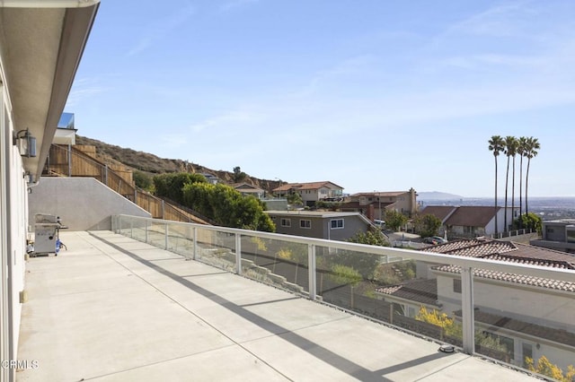 view of patio / terrace featuring a mountain view, a residential view, and fence