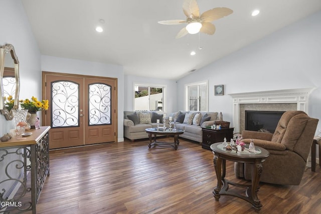 living room featuring french doors, recessed lighting, dark wood-type flooring, vaulted ceiling, and a glass covered fireplace