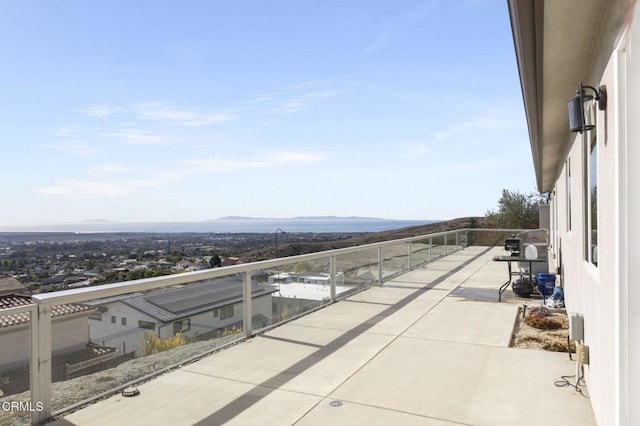 view of patio featuring a balcony and a mountain view