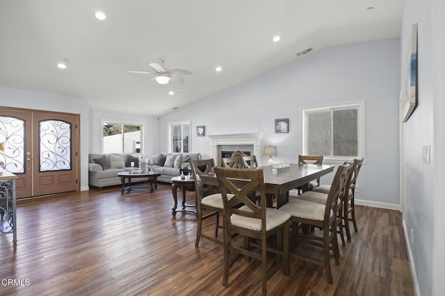 dining area with visible vents, lofted ceiling, dark wood-style floors, recessed lighting, and a fireplace