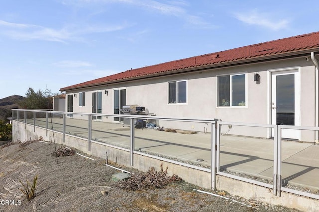 view of home's exterior featuring a tile roof and stucco siding