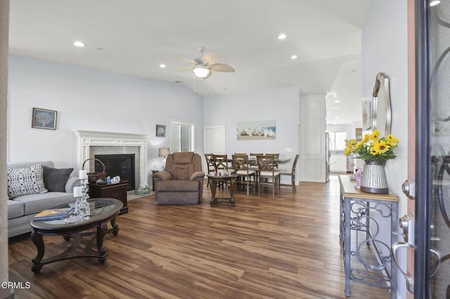 living area featuring recessed lighting, a fireplace, dark wood finished floors, ceiling fan, and vaulted ceiling