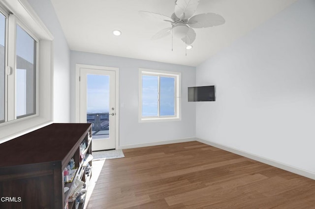 interior space with baseboards, ceiling fan, wood finished floors, and recessed lighting