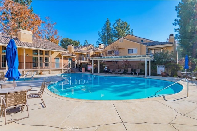 view of pool featuring a pergola and a patio