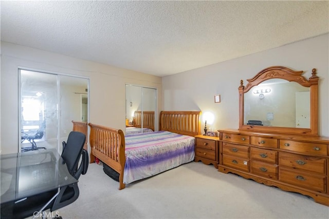 carpeted bedroom featuring a textured ceiling