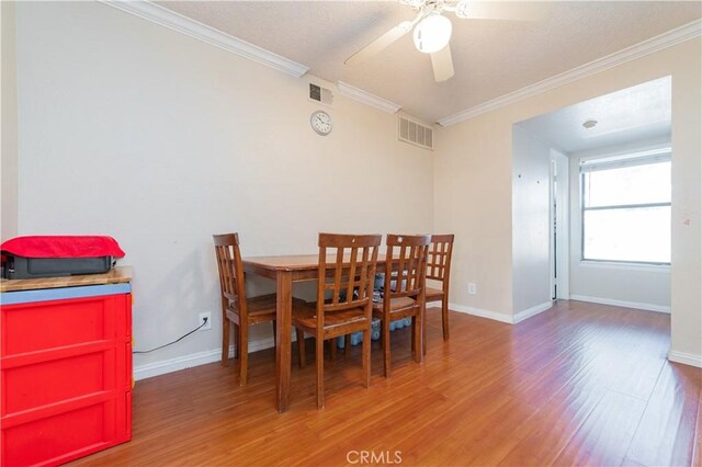 dining space featuring hardwood / wood-style floors, ceiling fan, and ornamental molding