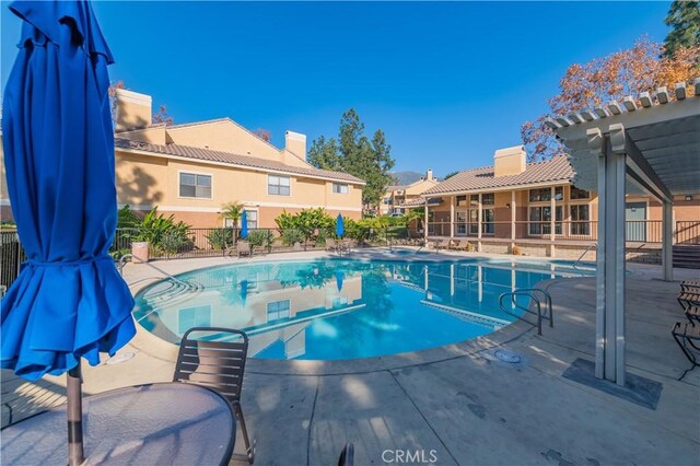 view of swimming pool with a pergola and a patio