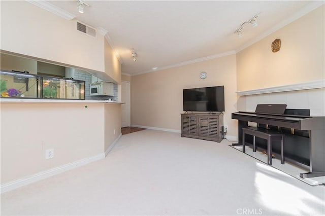 carpeted living room with crown molding and track lighting