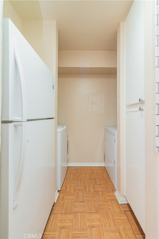 laundry area featuring independent washer and dryer and light parquet flooring
