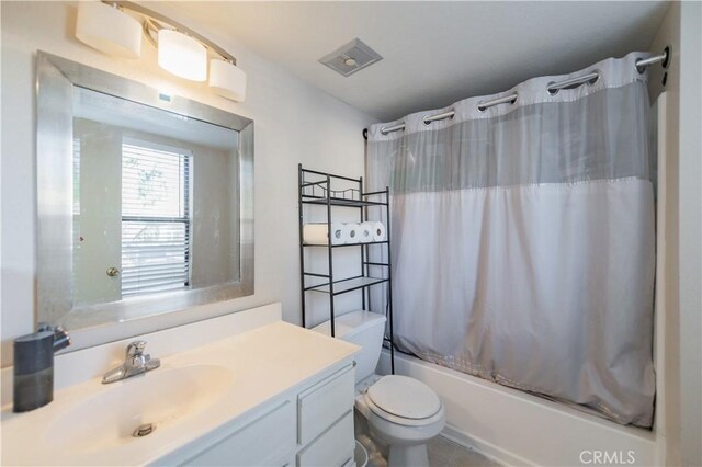 full bathroom with shower / tub combo, vanity, and toilet