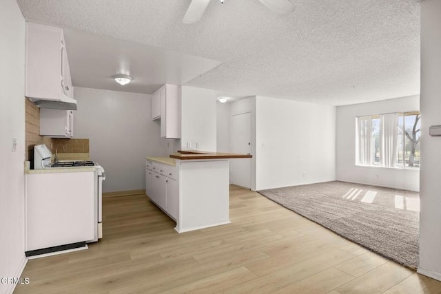 kitchen featuring a textured ceiling, white cabinetry, white range, and light wood-type flooring