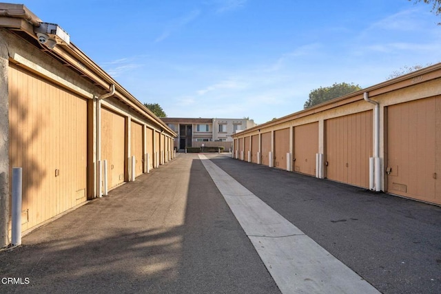 view of road featuring community garages