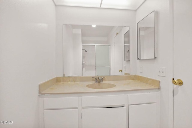 bathroom with a stall shower and vanity