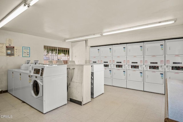 community laundry room featuring light floors, stacked washer / drying machine, and independent washer and dryer