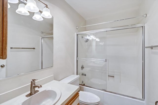 full bathroom with vanity, toilet, and combined bath / shower with glass door