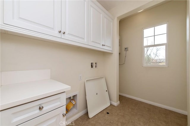 washroom featuring light tile patterned flooring, cabinets, and washer hookup