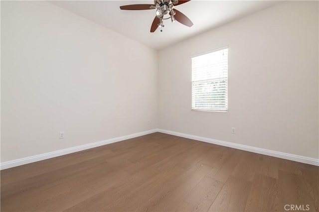 empty room featuring ceiling fan and hardwood / wood-style floors