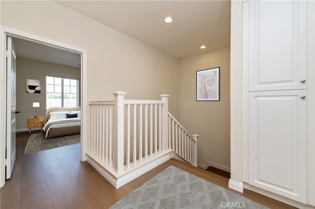 hall with hardwood / wood-style floors