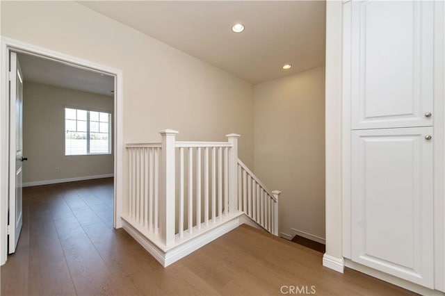 hall with hardwood / wood-style flooring