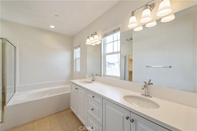 bathroom featuring plus walk in shower, vanity, and tile patterned floors