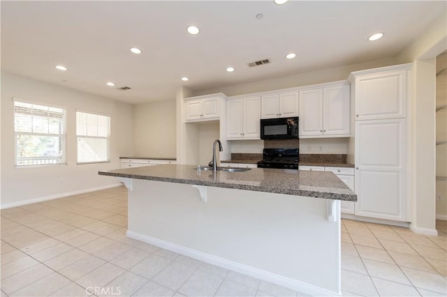 kitchen with black appliances, sink, a center island with sink, and white cabinets