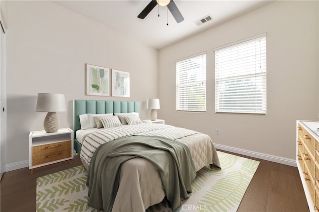 bedroom with ceiling fan and dark hardwood / wood-style floors