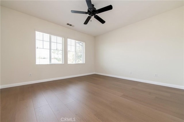 unfurnished room with ceiling fan and dark hardwood / wood-style flooring