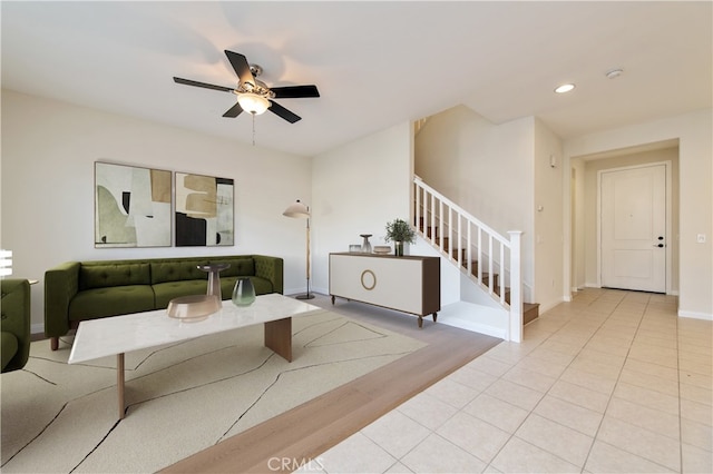 living room featuring ceiling fan and light hardwood / wood-style flooring