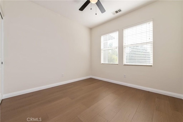 empty room with ceiling fan and hardwood / wood-style floors