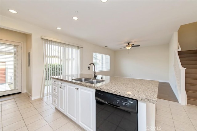 kitchen featuring a wealth of natural light, white cabinetry, sink, and black dishwasher