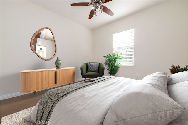 bedroom with hardwood / wood-style floors and ceiling fan