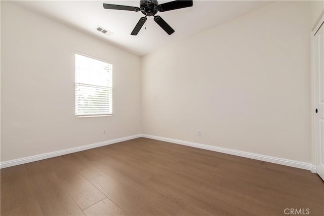 unfurnished room with ceiling fan and dark wood-type flooring