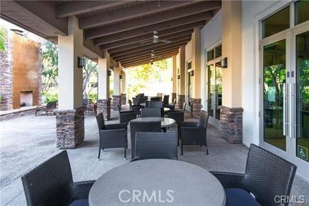 view of patio with an outdoor stone fireplace