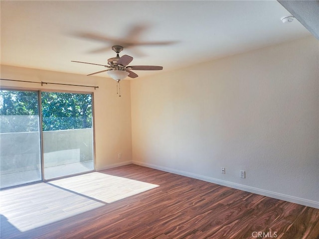 spare room with ceiling fan and dark hardwood / wood-style flooring