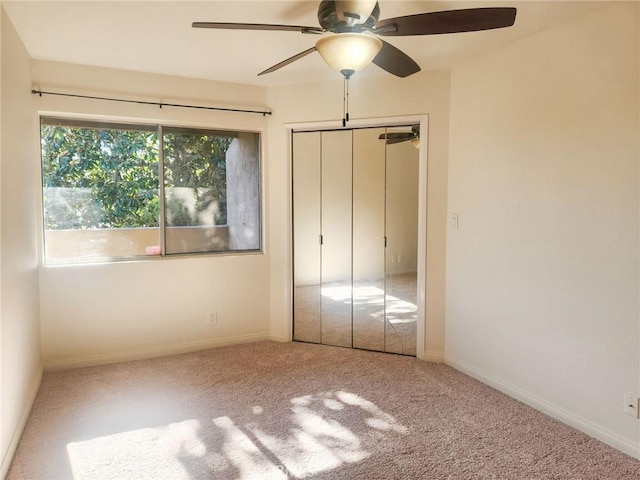 unfurnished bedroom featuring ceiling fan, carpet floors, and a closet