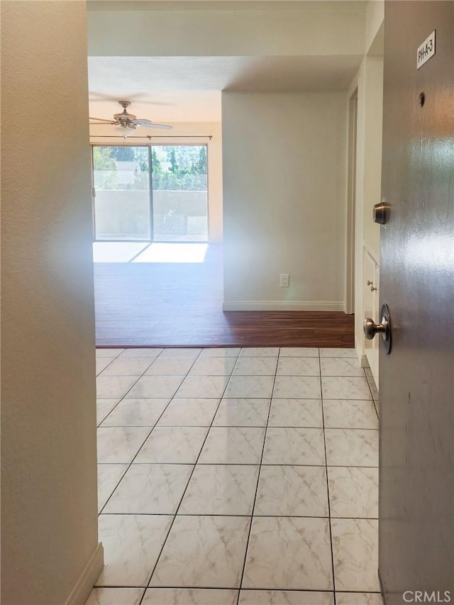 unfurnished room with ceiling fan and light wood-type flooring