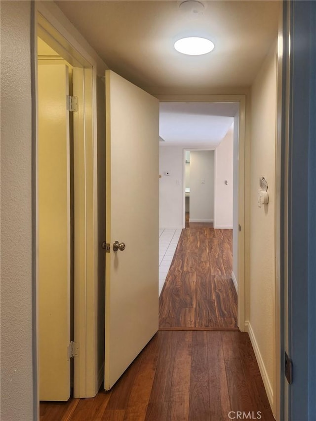 corridor featuring hardwood / wood-style floors