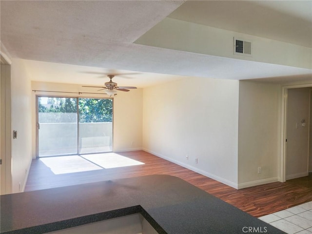 spare room featuring light hardwood / wood-style flooring and ceiling fan