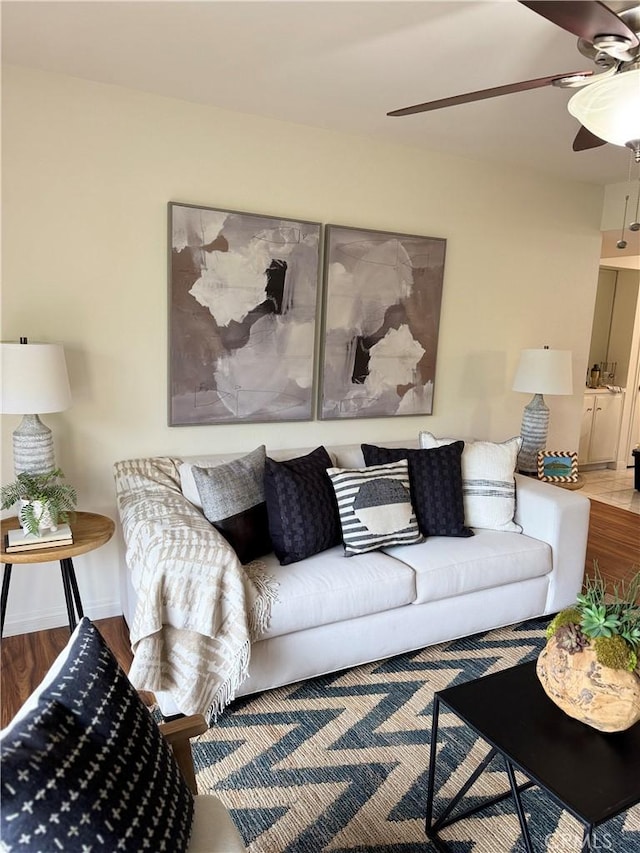 living room with hardwood / wood-style floors and ceiling fan