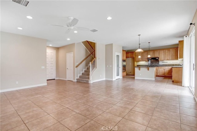 unfurnished living room with ceiling fan and light tile patterned floors