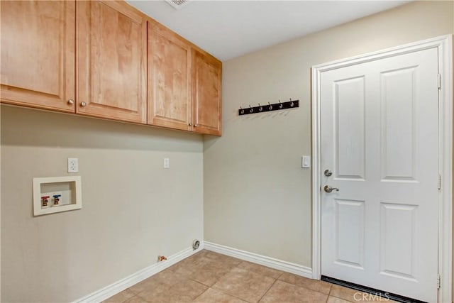 clothes washing area with gas dryer hookup, light tile patterned flooring, cabinets, and hookup for a washing machine